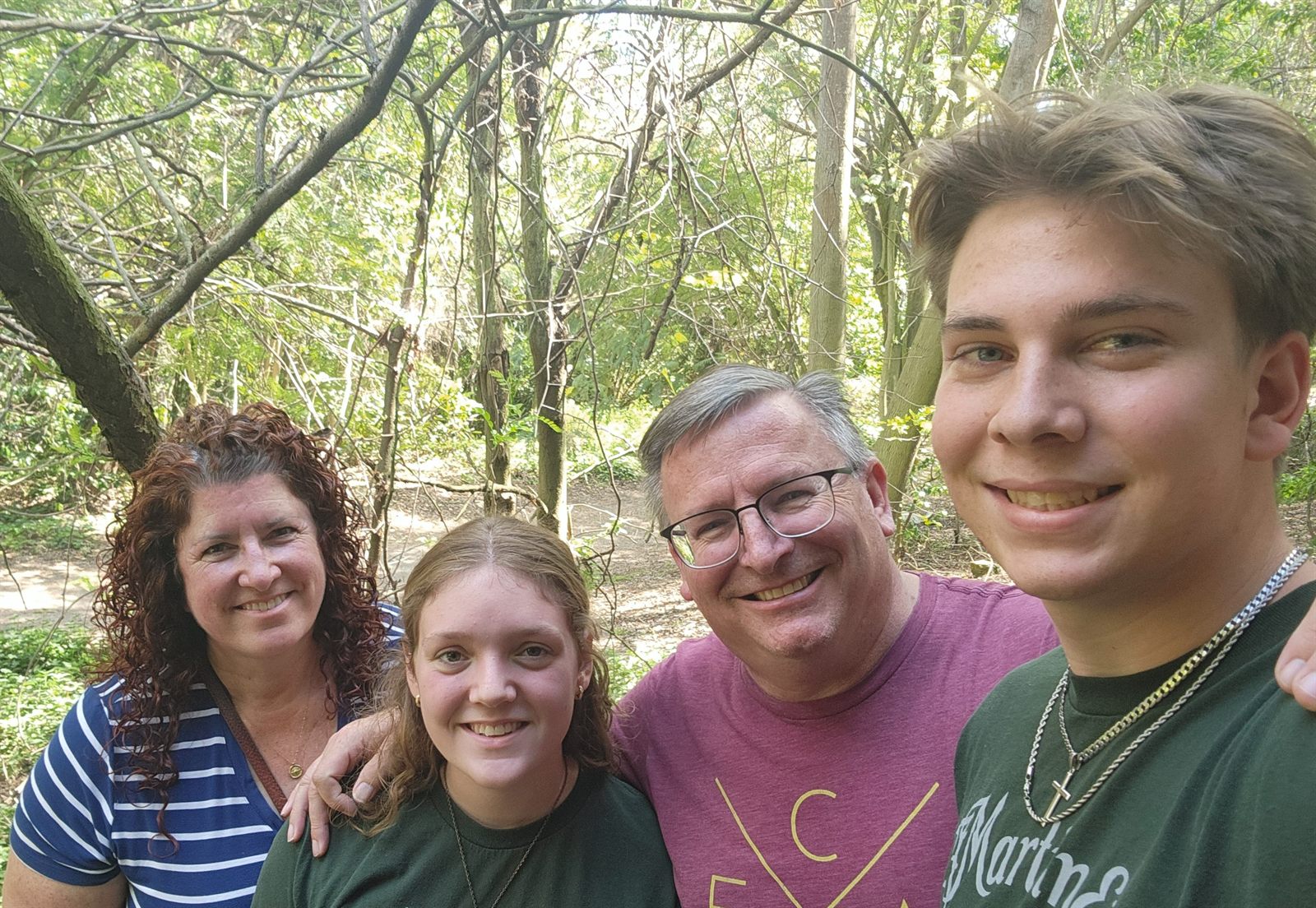 The Cole family hiking on a wooded trail